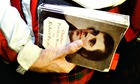 Man holds Robert Burns book