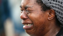 Tawandra Carr, who said she was best friends with Alton Sterling, cries while people gather outside the convenience store on July 6.