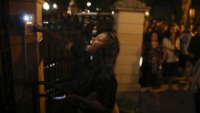 A woman rings the doorbell at the gate of the governor's home in Minnesota following Castile's shooting on July 6.
