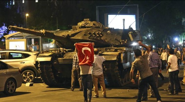 A tank moves into position as Turkish people attempt to stop them, in Ankara, Turkey, early Saturday, July 16, 2016. Turkey's armed forces said it "fully seized control" of the country Friday and its president responded by calling on Turks to take to the streets in a show of support for the government. A loud explosion was heard in the capital, Ankara, fighter jets buzzed overhead, gunfire erupted outside military headquarters and vehicles blocked two major bridges in Istanbul. (AP Photo)